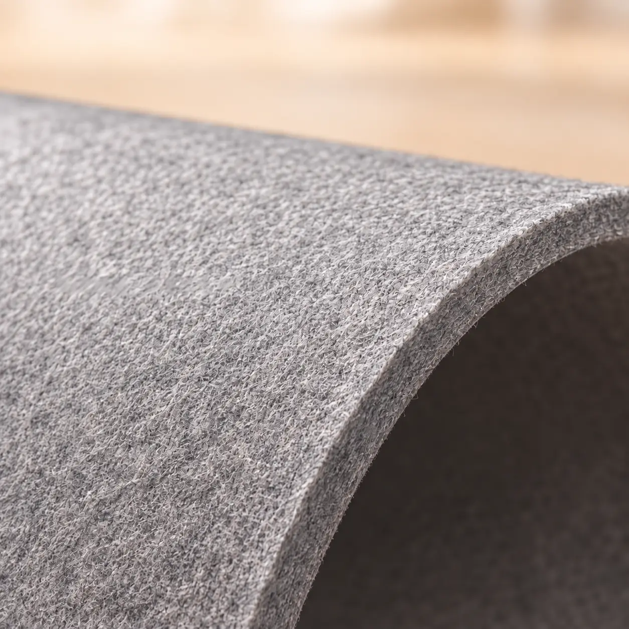 Light gray felt sheet showing flexibility, edge thickness and fiber texture